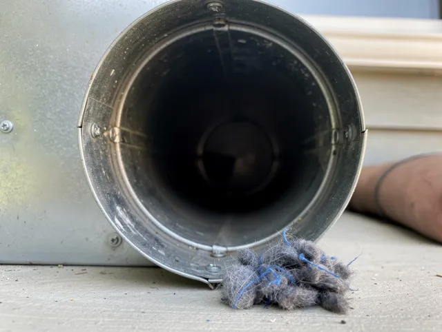 Windsor Dryer Vent Cleaning technician using specialized equipment to clear severe dryer vent blockage in Windsor